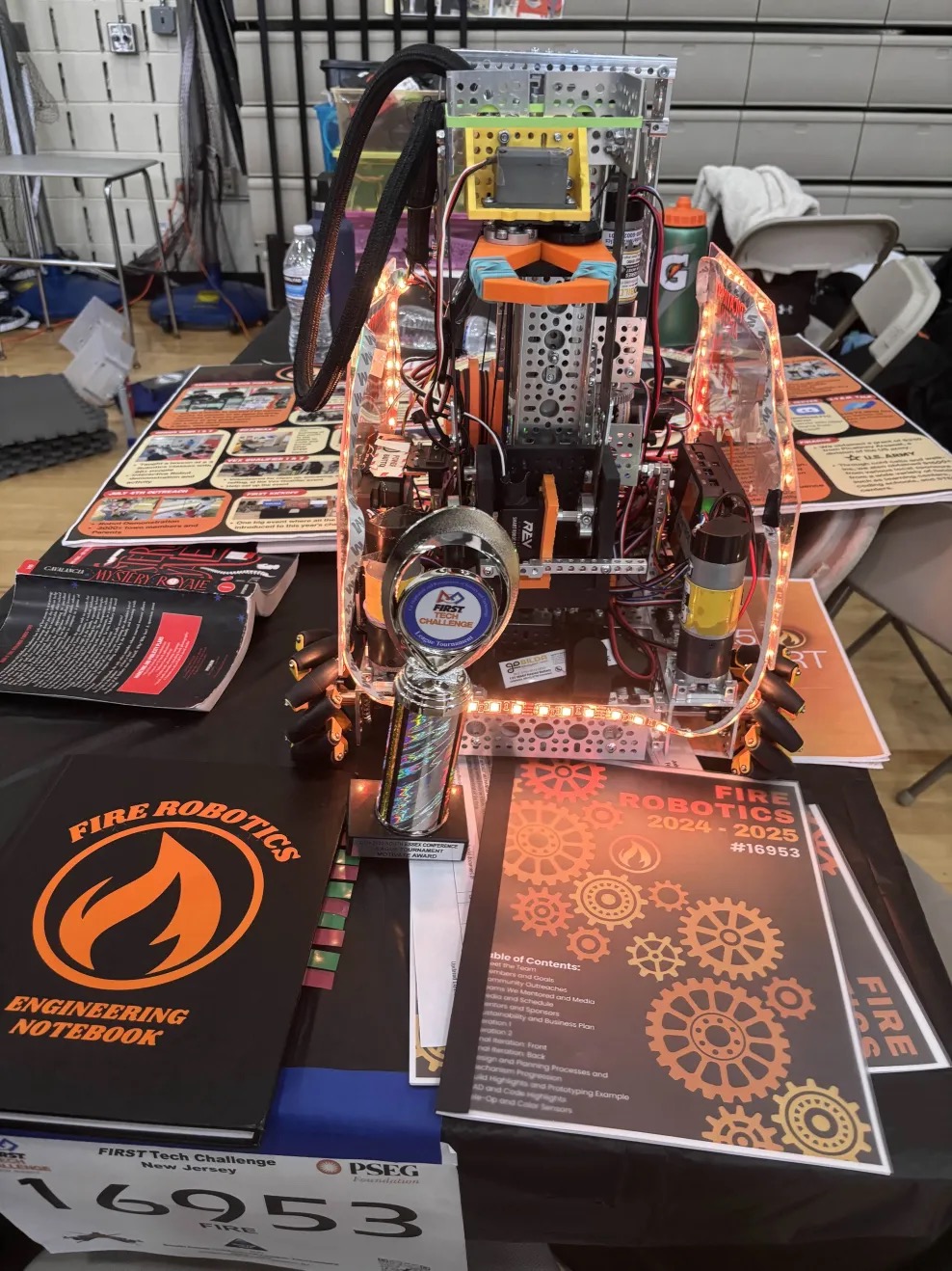 Fire Robotics engineering notebook, portfolio, and award at the judging table